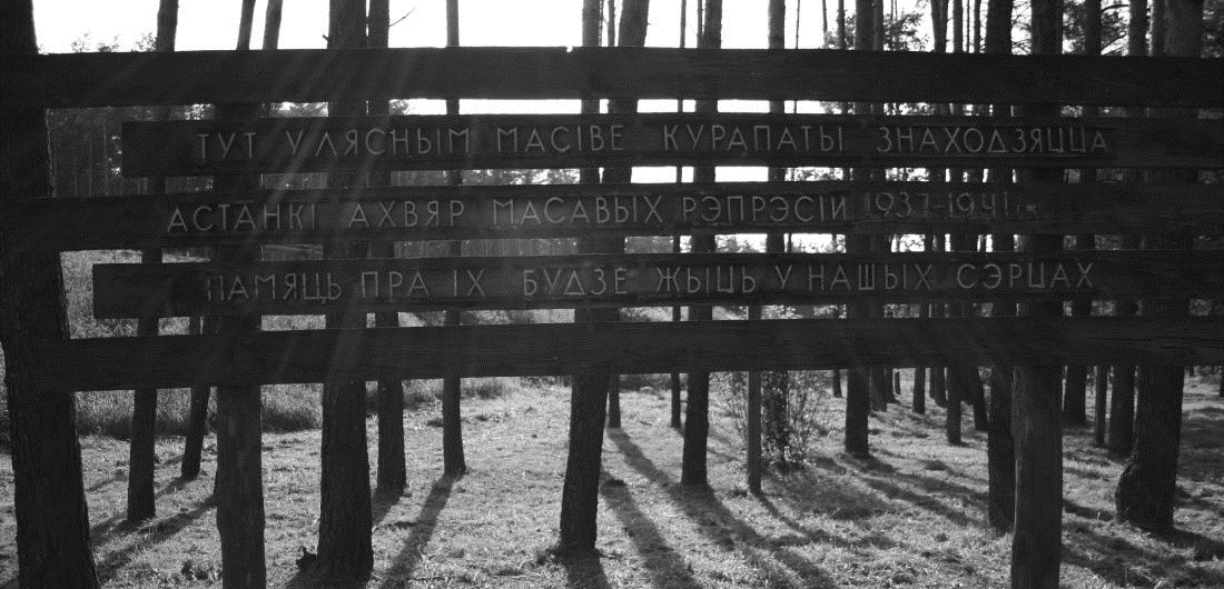 Foto: Querlatten an Holzstämmen mit Inschrift